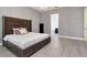 Spacious bedroom features a large upholstered headboard and leads into an ensuite bathroom at 10528 Bermuda Isle Dr, Tampa, FL 33647