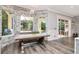 Breakfast nook surrounded by stone walls and windows overlooking the outdoor area at 10528 Bermuda Isle Dr, Tampa, FL 33647