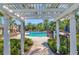 Community pool area features a pergola, lounge chairs, and well-maintained landscaping at 10528 Bermuda Isle Dr, Tampa, FL 33647