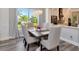 Elegant dining room featuring a modern chandelier, neutral tones, and a seamless flow into the kitchen area at 10528 Bermuda Isle Dr, Tampa, FL 33647