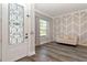 Inviting foyer with decorative door, stylish accent wall, wood floors and natural light creating a warm welcome at 10528 Bermuda Isle Dr, Tampa, FL 33647
