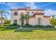 Stately two-story home featuring manicured landscaping and a barrel tile roof at 10528 Bermuda Isle Dr, Tampa, FL 33647