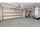 Spacious garage with ample storage, a large garage door, and a basketball hoop for recreation at 10528 Bermuda Isle Dr, Tampa, FL 33647