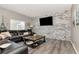 Inviting living room features a modern stone wall and hardwood floors at 10528 Bermuda Isle Dr, Tampa, FL 33647