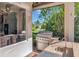 Outdoor kitchen equipped with a stainless steel grill, a sink, and granite countertops, perfect for entertaining at 10528 Bermuda Isle Dr, Tampa, FL 33647
