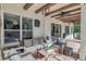 Cozy covered patio with comfortable seating, ceiling fan, and exposed wood beams at 10528 Bermuda Isle Dr, Tampa, FL 33647