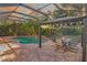 Evening view of a screened-in pool and patio area with a dining gazebo at 10528 Bermuda Isle Dr, Tampa, FL 33647