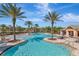 Resort-style pool with palm trees, sun loungers, and a clubhouse for residents' enjoyment at 10528 Bermuda Isle Dr, Tampa, FL 33647