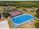 Aerial shot of outdoor facilities, including tennis, volleyball, and blue roller hockey rink at 10528 Bermuda Isle Dr, Tampa, FL 33647