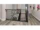 Elegant staircase with a decorative iron railing and modern gray flooring at 10528 Bermuda Isle Dr, Tampa, FL 33647