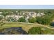 Scenic aerial view of homes with lush landscaping, ponds, and fairways in the neighborhood at 11209 Pocket Brook Dr, Tampa, FL 33635