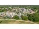 Aerial view of a residential neighborhood showcasing well-maintained homes, green trees, and nearby golf course at 11209 Pocket Brook Dr, Tampa, FL 33635