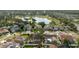 An aerial view shows the home is close to a pond and golf course with mature trees on the property at 11209 Pocket Brook Dr, Tampa, FL 33635