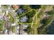 An aerial view showcases the home's proximity to a golf course and lake, highlighted by a yellow outline at 11209 Pocket Brook Dr, Tampa, FL 33635