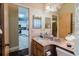 Bathroom showcasing marble counter, sink, mirror, fixtures, and access to the kitchen at 11209 Pocket Brook Dr, Tampa, FL 33635