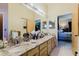 Bathroom featuring double sinks, lots of counter space, and a view into the bedroom at 11209 Pocket Brook Dr, Tampa, FL 33635