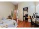 Bedroom featuring wood floors, door to another room, closet with contents, a bed, and a desk at 11209 Pocket Brook Dr, Tampa, FL 33635