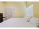 Bright bedroom featuring a window with blinds, wood floors, and a spacious closet with white paneled doors at 11209 Pocket Brook Dr, Tampa, FL 33635