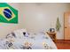 Bedroom featuring wood floors, a bed, a small side table, and a Brazilian flag at 11209 Pocket Brook Dr, Tampa, FL 33635