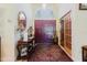 Elegant foyer featuring a decorative table, a large mirror, and a patterned rug leading to the front door at 11209 Pocket Brook Dr, Tampa, FL 33635
