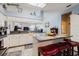 Spacious eat-in kitchen with breakfast bar, white cabinets, and modern tile flooring at 11209 Pocket Brook Dr, Tampa, FL 33635
