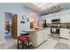 Cozy kitchen with an island with red stools, stainless steel appliances, and a unique tiled backsplash at 11209 Pocket Brook Dr, Tampa, FL 33635