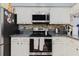 Modern kitchen featuring white cabinets, stainless steel appliances, and granite countertops for a sleek design at 11209 Pocket Brook Dr, Tampa, FL 33635