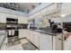 Bright kitchen featuring white cabinets, granite countertops, and a mirrored backsplash for enhanced visibility at 11209 Pocket Brook Dr, Tampa, FL 33635