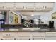 Kitchen with granite countertops, white cabinetry, and a mirrored backsplash with a view to the living area at 11209 Pocket Brook Dr, Tampa, FL 33635