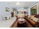 Bright living room with an open concept design, tile floors, comfortable seating, and an adjacent dining area at 11209 Pocket Brook Dr, Tampa, FL 33635