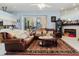 Cozy living room with fireplace, tile floors, comfortable seating and a view of the open floor plan at 11209 Pocket Brook Dr, Tampa, FL 33635
