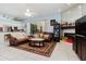 Open-concept living room featuring a fireplace, comfortable seating, and tile floors at 11209 Pocket Brook Dr, Tampa, FL 33635