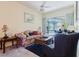 Comfortable living room with a ceiling fan and a view of the screened outdoor patio and pool at 11209 Pocket Brook Dr, Tampa, FL 33635