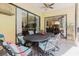Screened patio with a dining table and seating area with a view of the living room at 11209 Pocket Brook Dr, Tampa, FL 33635