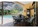Screened patio features a view of the pool and backyard, perfect for dining and relaxation at 11209 Pocket Brook Dr, Tampa, FL 33635