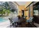 Screened patio features a view of the pool and backyard, perfect for dining and relaxation at 11209 Pocket Brook Dr, Tampa, FL 33635