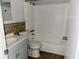Cozy bathroom with a shower-tub combo, vanity sink, and decorative tile accents at 11405 3Rd N St # 2, St Petersburg, FL 33716