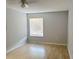 Bedroom featuring wood laminate flooring, neutral paint, and a large window at 11405 3Rd N St # 2, St Petersburg, FL 33716