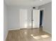 Bedroom featuring wood laminate flooring, neutral paint, and two closets at 11405 3Rd N St # 2, St Petersburg, FL 33716