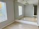 Dining room featuring light wood floors, large mirror and natural light from the window at 11405 3Rd N St # 2, St Petersburg, FL 33716