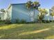 Two-story apartment building featuring lush landscaping, palm trees, and light green exterior at 11405 3Rd N St # 2, St Petersburg, FL 33716