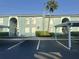 Two-story apartment building featuring covered parking and light green exterior at 11405 3Rd N St # 2, St Petersburg, FL 33716