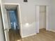Hallway featuring wood laminate flooring and multiple closets at 11405 3Rd N St # 2, St Petersburg, FL 33716