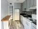 Kitchen features gray cabinets, mosaic backsplash, and essential appliances for easy cooking at 11405 3Rd N St # 2, St Petersburg, FL 33716