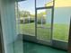 Enclosed patio with views of the green lawn and parking lot at 11405 3Rd N St # 2, St Petersburg, FL 33716