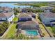 Aerial view of a beautiful home with a screened-in pool and a view of the lake at 11852 Lake Lucaya Dr, Riverview, FL 33579