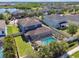 An aerial view of the property shows the screened-in pool, backyard, and neighborhood at 11852 Lake Lucaya Dr, Riverview, FL 33579