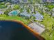Aerial view of the community amenities including the pool, clubhouse, beach, and lake at 11852 Lake Lucaya Dr, Riverview, FL 33579