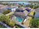 Aerial view of the property featuring the screened pool, backyard and the adjacent lake at 11852 Lake Lucaya Dr, Riverview, FL 33579