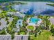 Aerial view of the community amenities including the pool, splash pad, clubhouse and large lake at 11852 Lake Lucaya Dr, Riverview, FL 33579